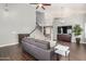 Bright living room offering wood-look floors, modern lighting, and a comfortable gray sofa at 901 N Woodburne Dr, Chandler, AZ 85224