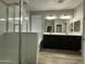 Bathroom featuring a glass-enclosed shower, a soaking tub, and a dual sink vanity, all well lit at 9017 W Kirby Ave, Tolleson, AZ 85353