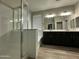 Modern bathroom featuring a glass-enclosed shower, a soaking tub, and a dual sink vanity at 9017 W Kirby Ave, Tolleson, AZ 85353