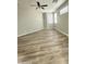 Spacious bedroom featuring neutral walls, modern ceiling fan, and plank flooring for a clean and airy space at 9017 W Kirby Ave, Tolleson, AZ 85353