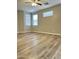 Airy bedroom with multiple windows, a ceiling fan, and plank flooring, creating a comfortable retreat at 9017 W Kirby Ave, Tolleson, AZ 85353