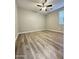 Bright bedroom with plank flooring, ceiling fan and neutral walls. Natural light pours in to make it an airy space at 9017 W Kirby Ave, Tolleson, AZ 85353