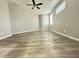 Spacious bedroom featuring neutral walls, modern ceiling fan, and plank flooring for a clean and airy space at 9017 W Kirby Ave, Tolleson, AZ 85353