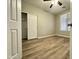 Cozy bedroom with plank flooring, closet with sliding doors, neutral walls and bright natural light at 9017 W Kirby Ave, Tolleson, AZ 85353