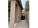 Exterior side view featuring the air conditioning unit and a gravel surface at 9017 W Kirby Ave, Tolleson, AZ 85353