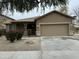 Charming single-Gathering home featuring a two-car garage and landscaped front yard at 9017 W Kirby Ave, Tolleson, AZ 85353