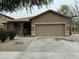 Charming single-Gathering home featuring a two-car garage and landscaped front yard at 9017 W Kirby Ave, Tolleson, AZ 85353