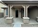 Covered front porch view showing the entryway and a glimpse of the interior at 9017 W Kirby Ave, Tolleson, AZ 85353