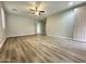 Bright living room featuring vinyl floors, a ceiling fan, and an open layout at 9017 W Kirby Ave, Tolleson, AZ 85353