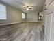 Spacious living room with modern vinyl flooring, a ceiling fan, and natural light at 9017 W Kirby Ave, Tolleson, AZ 85353