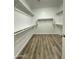 Spacious walk-in closet with ample shelving and modern flooring, offering great storage solutions at 9017 W Kirby Ave, Tolleson, AZ 85353