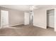 Neutral bedroom with plush carpet, ceiling fan, closet, and an attached bathroom at 904 W Tulane Dr, Tempe, AZ 85283