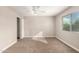 Bright bedroom featuring neutral carpet, ceiling fan, and a large window at 904 W Tulane Dr, Tempe, AZ 85283