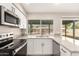 Well-lit kitchen with stainless steel appliances, granite countertops, and white cabinetry at 904 W Tulane Dr, Tempe, AZ 85283