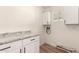 Bright laundry room with sleek cabinets and a granite countertop at 904 W Tulane Dr, Tempe, AZ 85283