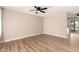 Open-concept living room with wood-look floors and a view into the kitchen area at 904 W Tulane Dr, Tempe, AZ 85283