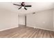 Spacious living room featuring wood-look floors, a modern ceiling fan, and neutral wall color at 904 W Tulane Dr, Tempe, AZ 85283