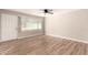 Bright living room with wood-look flooring, a ceiling fan, and a front-facing window at 904 W Tulane Dr, Tempe, AZ 85283