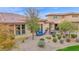 Aerial view of backyard with patio and outdoor seating surrounded by desert landscaping and a well maintained lawn at 908 E Cereus Pass, Queen Creek, AZ 85140