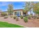 The backyard features desert landscaping and a covered patio with outdoor seating at 908 E Cereus Pass, Queen Creek, AZ 85140