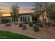 The backyard features desert landscaping and a covered patio with outdoor seating at 908 E Cereus Pass, Queen Creek, AZ 85140