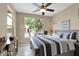 Bedroom with neutral colors, ceiling fan, and a view to the front yard at 908 E Cereus Pass, Queen Creek, AZ 85140