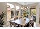 Dining room with a rustic wood table and chandelier, bathed in natural light at 908 E Cereus Pass, Queen Creek, AZ 85140