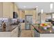 A modern kitchen featuring stainless steel appliances, mosaic tile backsplash, and granite countertops at 908 E Cereus Pass, Queen Creek, AZ 85140