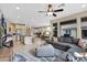 Open-concept layout connecting the kitchen, dining, and living area with large windows and neutral decor at 908 E Cereus Pass, Queen Creek, AZ 85140