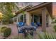 This covered patio shows an outdoor seating area with a dining table and additional sofa and chairs to enjoy the outdoors at 908 E Cereus Pass, Queen Creek, AZ 85140