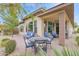 This covered patio shows an outdoor seating area with a dining table and additional sofa and chairs to enjoy the outdoors at 908 E Cereus Pass, Queen Creek, AZ 85140