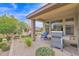 Covered patio featuring an outdoor kitchen, and an outdoor seating area for entertaining and enjoying the backyard at 908 E Cereus Pass, Queen Creek, AZ 85140