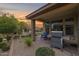 Covered patio featuring an outdoor kitchen, and an outdoor seating area for entertaining and enjoying the backyard at 908 E Cereus Pass, Queen Creek, AZ 85140