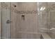 Modern shower with tiled walls, built in shelves, and glass door at 908 E Cereus Pass, Queen Creek, AZ 85140