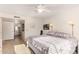 Serene bedroom with soft lighting, light floors, and access to an ensuite bathroom, creating a relaxing retreat at 9329 W Topeka Dr, Peoria, AZ 85382