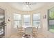 Cozy breakfast nook with abundant natural light and views of the surrounding landscape through large bay windows at 9329 W Topeka Dr, Peoria, AZ 85382