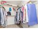 Walk-in closet featuring ample storage and wooden hanging rods for organized wardrobe solutions at 9329 W Topeka Dr, Peoria, AZ 85382