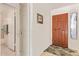 Inviting entryway featuring a solid front door, tile flooring, and natural light from a nearby window at 9329 W Topeka Dr, Peoria, AZ 85382