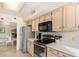 Well-equipped kitchen featuring stainless steel appliances, sleek countertops, and ample cabinet storage at 9329 W Topeka Dr, Peoria, AZ 85382