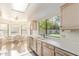 Bright kitchen with garden view, featuring tile floors, stainless steel sink and appliances at 9329 W Topeka Dr, Peoria, AZ 85382