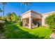 Covered patio area with outdoor seating overlooks the lush lawn, offering a perfect space for relaxation at 9329 W Topeka Dr, Peoria, AZ 85382