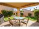 Covered patio featuring an outdoor dining area with room to enjoy outdoor living and entertaining at 9329 W Topeka Dr, Peoria, AZ 85382