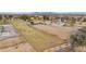 Aerial view of well-maintained horse property with fenced riding arena and pastures near residential area at 97 W Marilyn Way, San Tan Valley, AZ 85140