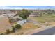 Aerial view of property with green pastures and serene pond, located near desert landscape at 97 W Marilyn Way, San Tan Valley, AZ 85140