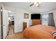 Bright bedroom showcases wood-look flooring, a ceiling fan, and an ensuite bathroom entrance at 97 W Marilyn Way, San Tan Valley, AZ 85140