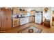 Functional kitchen featuring wooden cabinets and white appliances, offering a practical cooking space at 97 W Marilyn Way, San Tan Valley, AZ 85140