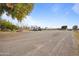 Expansive parking area with gravel surfaces, storage sheds, and agricultural equipment at 97 W Marilyn Way, San Tan Valley, AZ 85140