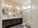 Well-lit bathroom featuring double sinks, a walk-in shower, and modern fixtures at 10332 W Potter Dr, Peoria, AZ 85382