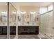 Bathroom features double sinks with dark wood cabinets and a glass-enclosed shower at 10332 W Potter Dr, Peoria, AZ 85382