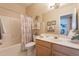 Well-lit bathroom features neutral tones, decorative accents, and shower-tub combo at 10332 W Potter Dr, Peoria, AZ 85382